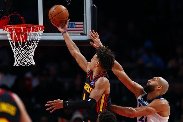 Hawks snap skid, rout Wolves behind Johnson image