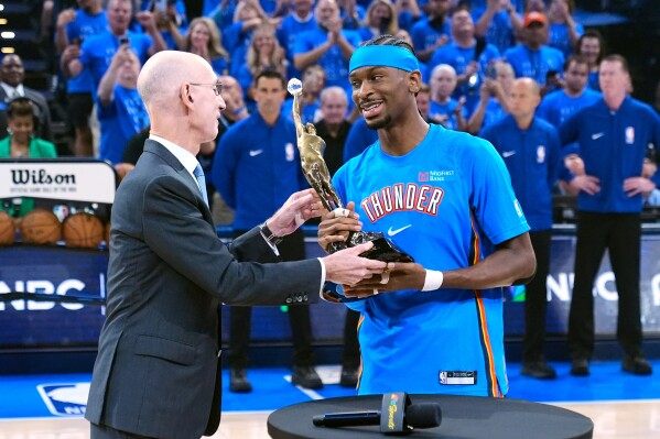 Shai Gilgeous-Alexander gets the MVP trophy from NBA Commissioner Adam Silver image